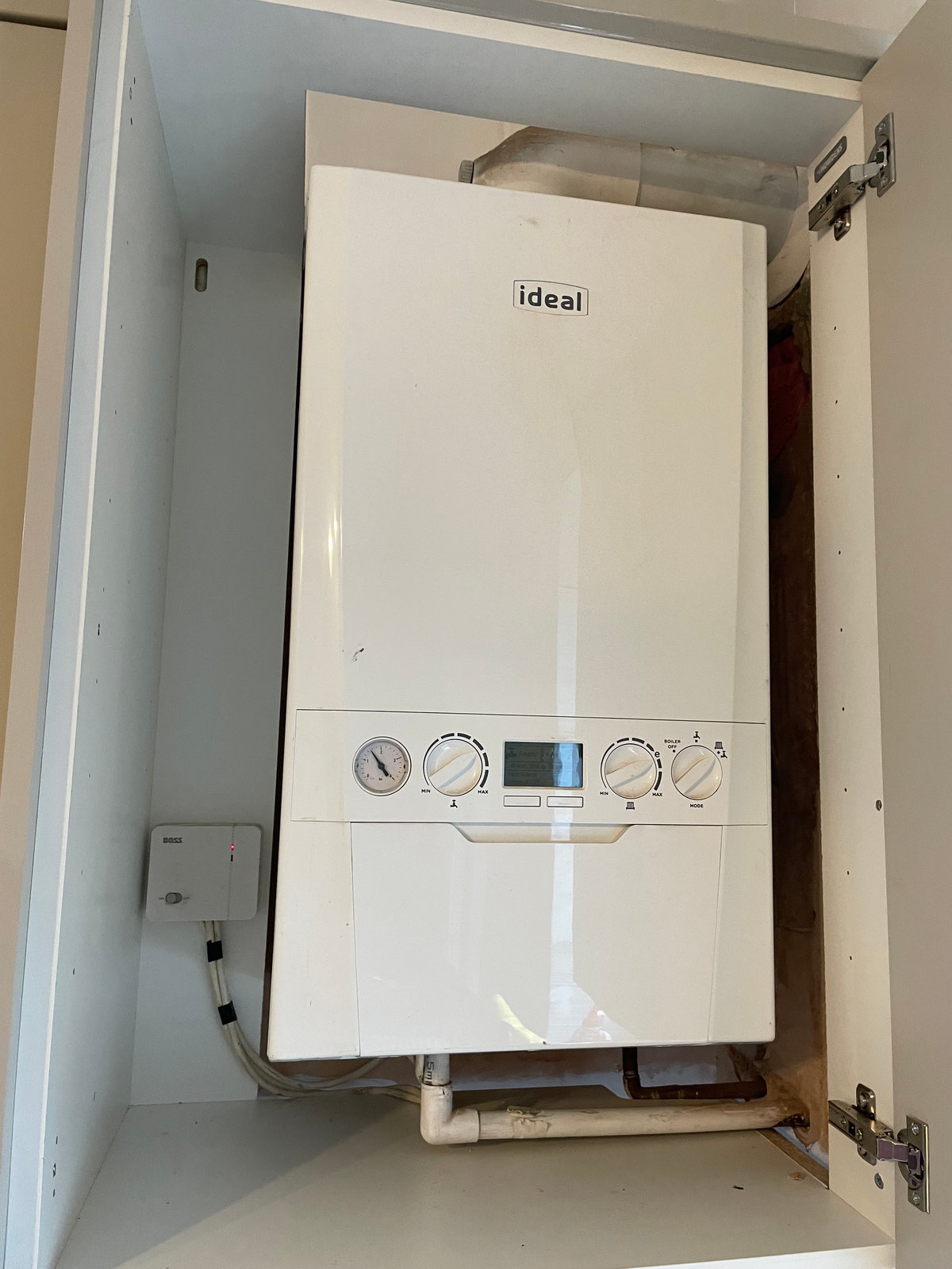 Newly fitted boiler in a kitchen cupboard
