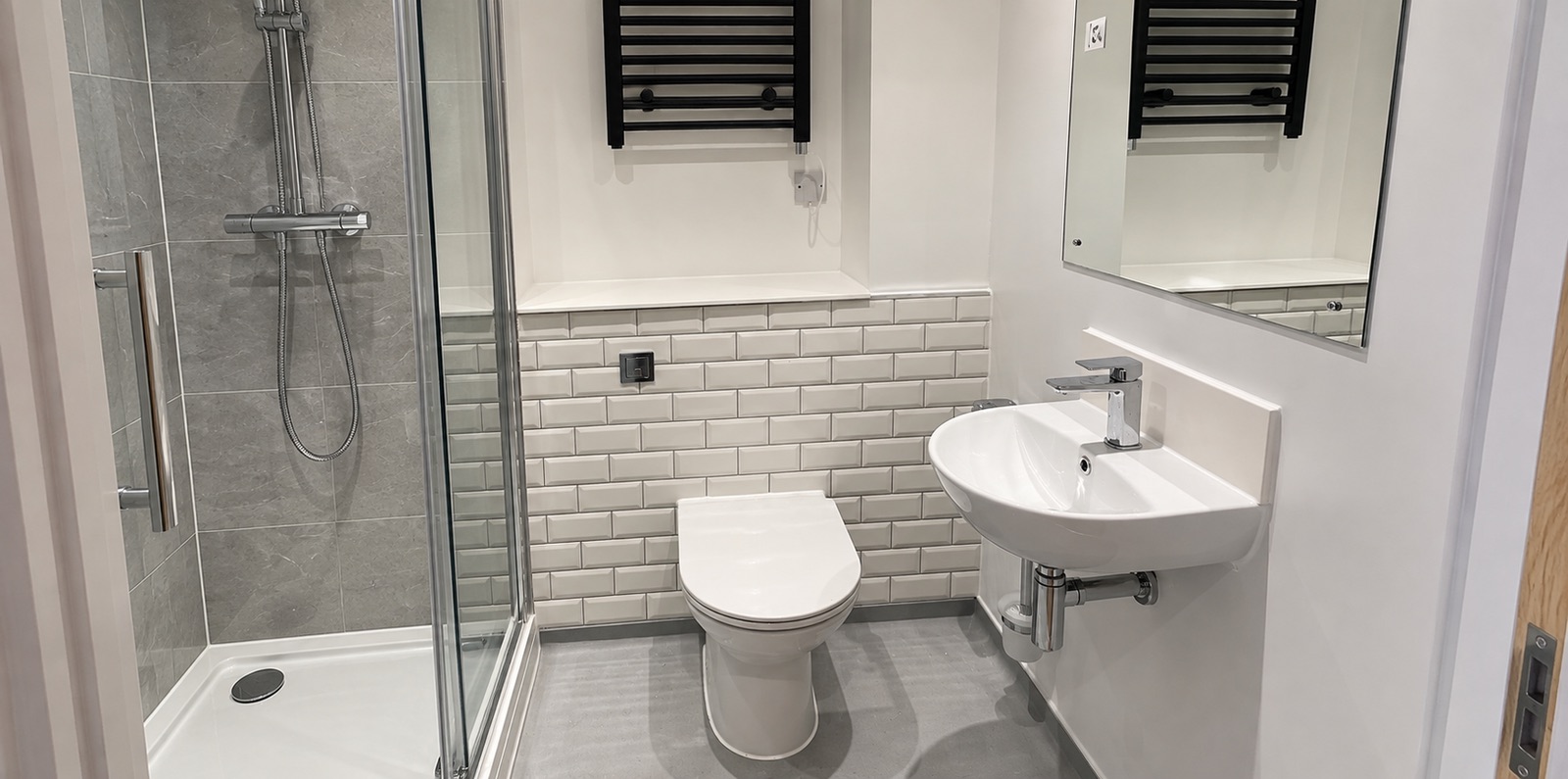 Walk-in shower, basin and heated towel rail