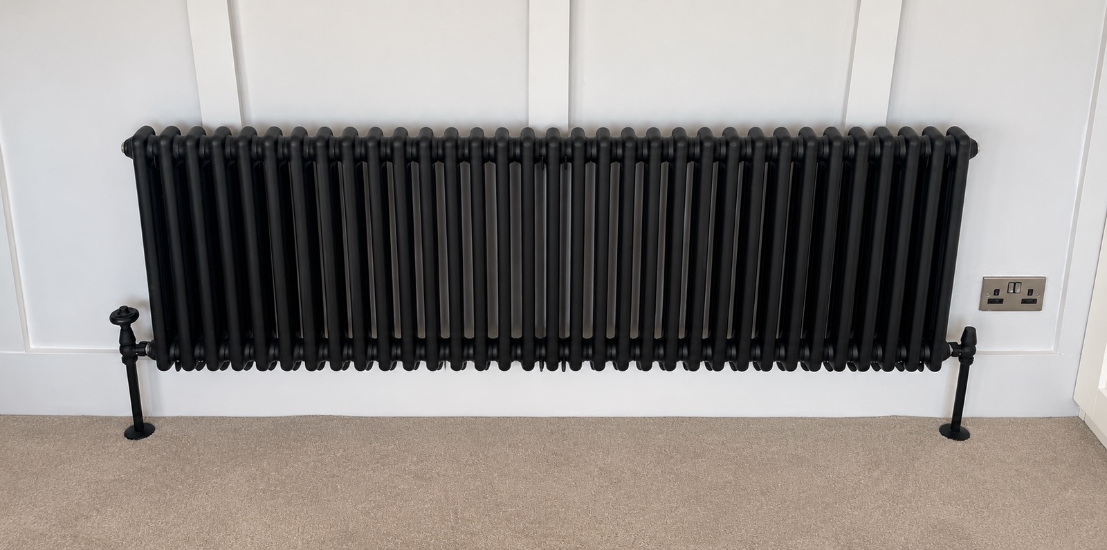 Anthracite column radiator fitted under a window
